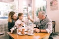 Modern grandfather giving high five his cute little granddaughter