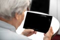 Modern grandma looking at the desk from a tablet, elderly women Royalty Free Stock Photo