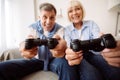 Modern grandparents. Senior couple playing video games Royalty Free Stock Photo