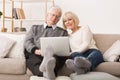 Modern Grandparents. Senior Couple Websurfing On Laptop