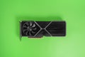 Modern graphic card on green surface. Massive radiator with two coolers Royalty Free Stock Photo