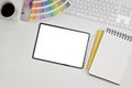 Modern graphic designer workspace top view with color palette, notepad, and digital tablet mockup