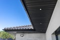 A modern graphite herringbone roof lining is attache.d to the trusses, visible turned on LED lights