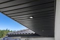 A modern graphite roof lining is attached to the trusses, visible turned on LED lights.