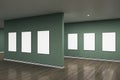 Modern gray gallery interior with blank mock up frames on wall and reflections on wooden flooring. Art, no people, museum and Royalty Free Stock Photo