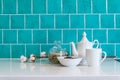 Kitchen features dark gray flat front cabinets paired with white quartz countertops and a glossy blue care tile. Royalty Free Stock Photo