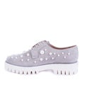 Modern gray suede women\'s shoes with white ribbed soles decorated with pearls isolated on a white background