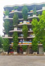 Modern green apartment building with lush vegetation