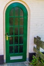 Modern green door, building entrance, small window pattern design, architecture background Royalty Free Stock Photo