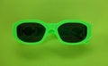 Modern green sunglasses isolate on a green background.Traveler and summer accessories Royalty Free Stock Photo