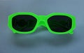 Modern green sunglasses isolate on a gray background.Traveler and summer accessories