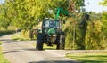 Modern green tractor cutting and maintaining hedge Royalty Free Stock Photo