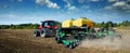 Modern, green tractor in the spring field work