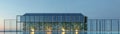 A modern greenhouse design featuring sleek architecture and vibrant greenery under a twilight sky Royalty Free Stock Photo