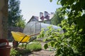 A modern greenhouse made of polycarbonate. Preparation of the garden for planting vegetables and fruits. Agricultural