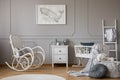 Modern grey baby nursery design in tenement house, copy space and poster on empty wall
