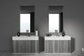 Modern grey bathroom interior with sink and two mirrors, window Royalty Free Stock Photo