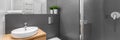 Panorama of modern grey bathroom with shower Royalty Free Stock Photo