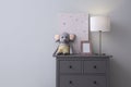 Modern chest of drawers near light wall in child room, space for text. Interior design Royalty Free Stock Photo