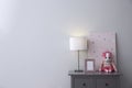 Grey chest of drawers near light wall in child room, space for text. Interior design Royalty Free Stock Photo
