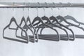 Modern grey empty hangers on neutral wall background