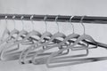 Modern grey empty hangers on neutral wall background