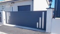Modern grey gate of home aluminum portal for outdoor door in suburbs house