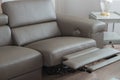 Modern grey leather sofa, with recliner in open position.