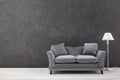 Modern grey sofa on grey wall background. Free space Royalty Free Stock Photo