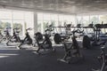 Modern gym interior with equipment, fitness exercise bikes Royalty Free Stock Photo