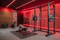 modern gym setup featuring weight bench, barbell, and exercise equipment in stylish red lit environment. space is designed for