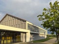 A modern gymnasium or gym building in warm golden hour light