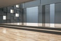 Modern hallway interior in building with glass doors and wooden flooring. Architecture and modern design concept. Royalty Free Stock Photo