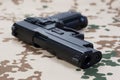 Modern hand gun on camouflaged uniform Royalty Free Stock Photo