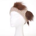Modern handmade woollen knitted headband on a white Doll head