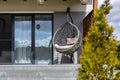 Modern hanging rattan chair with gray pillows on the garden terrace Royalty Free Stock Photo