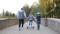 Modern happy family riding gyroscooters in the park