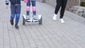 Modern happy family riding gyroscooters in the park