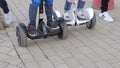 Modern happy family riding gyroscooters in the park