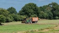 A modern harvester at grass harvest on a field