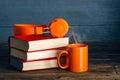 Modern headphones with stack of books and cup mug of tea coffee Royalty Free Stock Photo