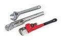 Different adjustable wrenches for plumbing work on a white background