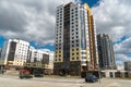 Modern high residential building on the background of clouds. View of the new area of the city. Beautiful multi-colored high-rise