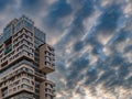A modern high-rise building against a dramatic sky with clouds. Royalty Free Stock Photo