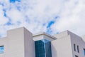 Modern High-Rise Building with Blue-Green Glass Panels and Gray Rectangular Tiles on the facade Royalty Free Stock Photo