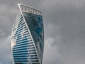 Modern high-rise building made of glass and concrete with small silhouettes of high-rise workers on the wall, copy space. Royalty Free Stock Photo