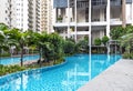 Modern high-rise residential apartment with a beautiful tropical garden and swimming pool Royalty Free Stock Photo