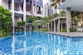 Modern high-rise residential apartment with a beautiful tropical garden and swimming pool Royalty Free Stock Photo