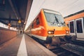 Modern high speed red commuter train at colorful sunset Royalty Free Stock Photo