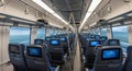 Modern High-Speed Train Interior with Entertainment Screens Royalty Free Stock Photo
